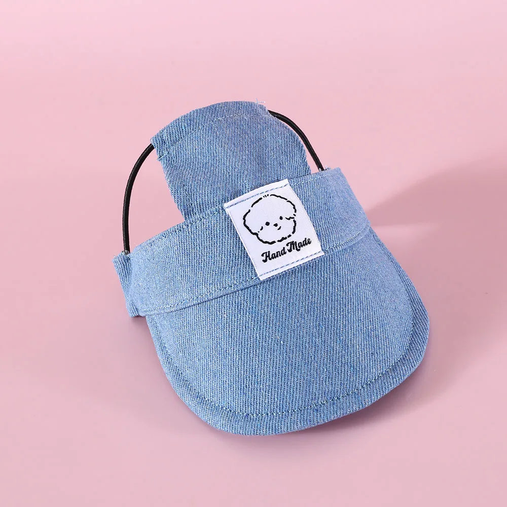 Blue pet hat with a label on a pink background