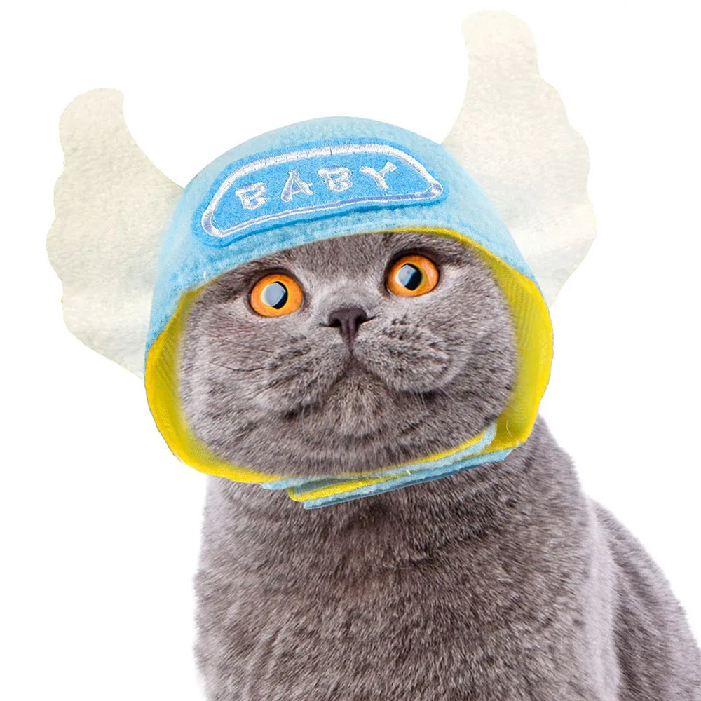 Cat wearing a baby hat with horns and a 'BABY' sign on a white background