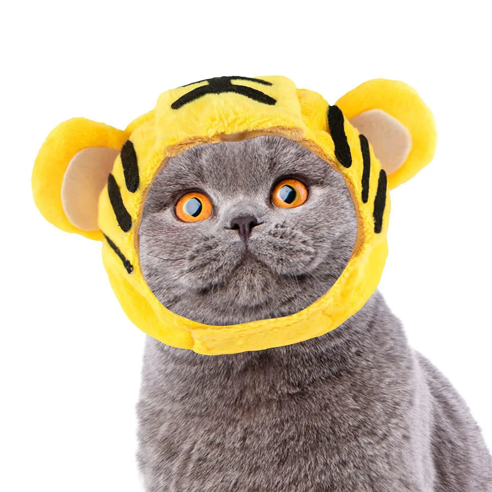 Cat wearing a yellow tiger costume hat with black stripes on a white background