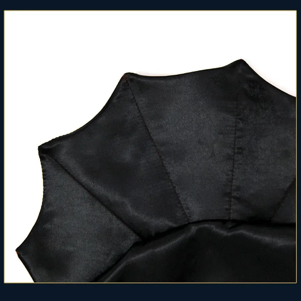 Close-up of a black satin pet cape fabric with folds on a white background