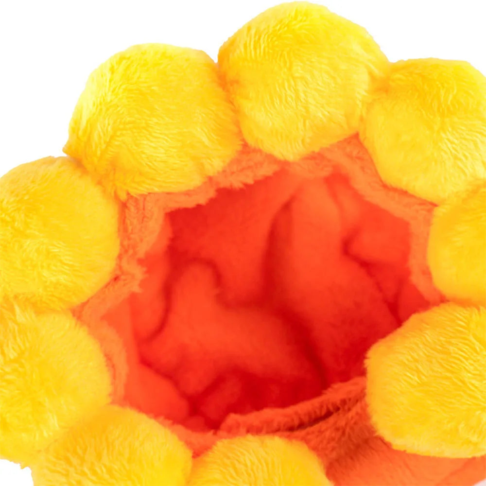 Close-up of a orange hat ball with yellow pom-poms on a white background