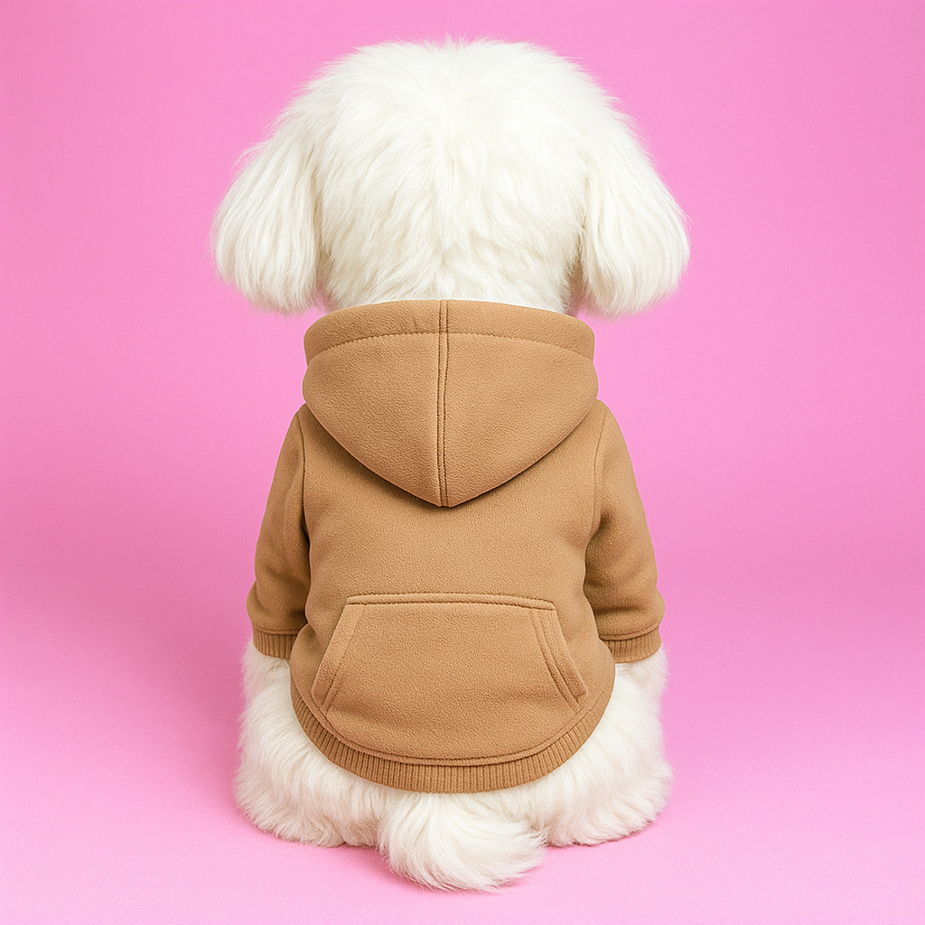 Dog wearing a brown hoodie against a pink background