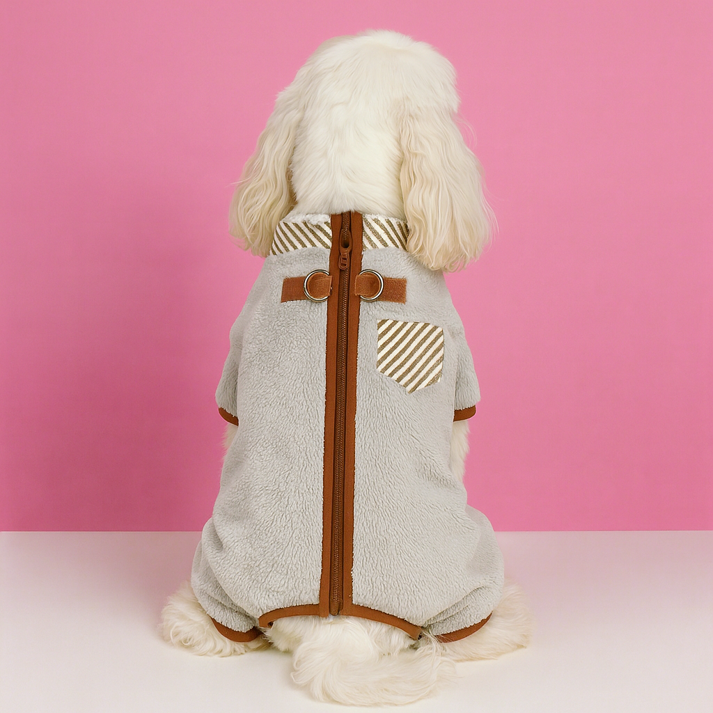 Dog wearing a gray outfit with brown accents on a pink background