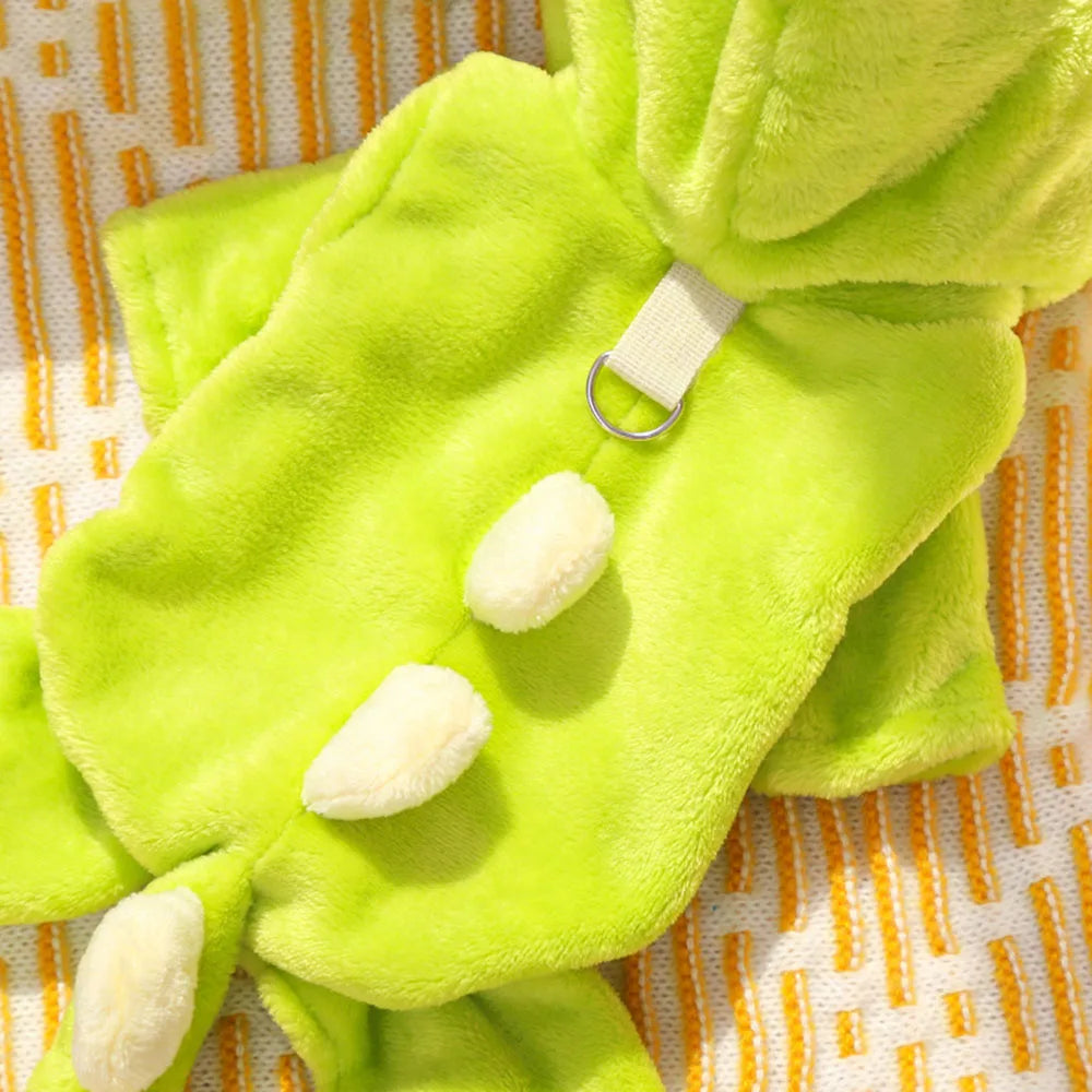 Green plush dino style dog costume with white accents