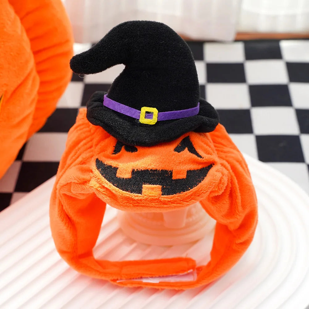 Halloween-themed plush pet hat with a pumpkin face and witch on a checkered floor.