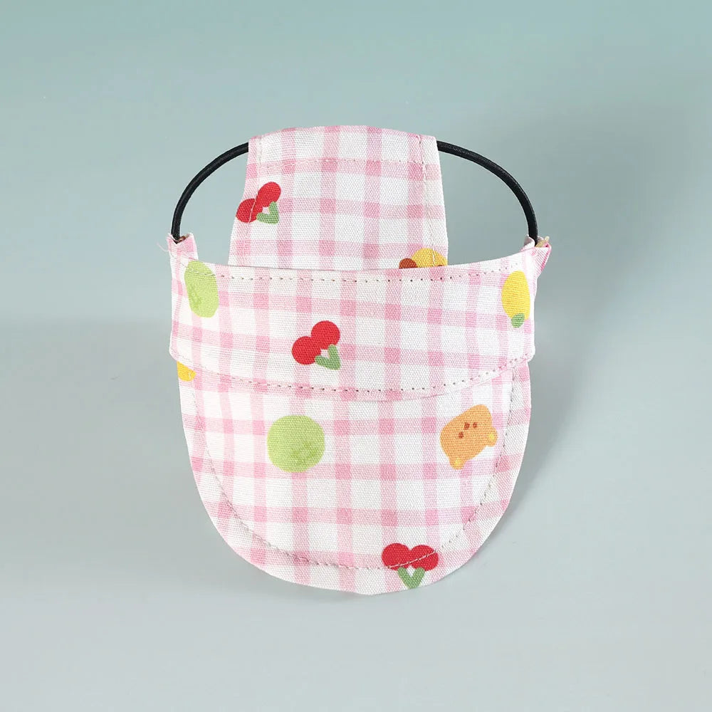 Pink checkered dog hat with cherry and leaf patterns 