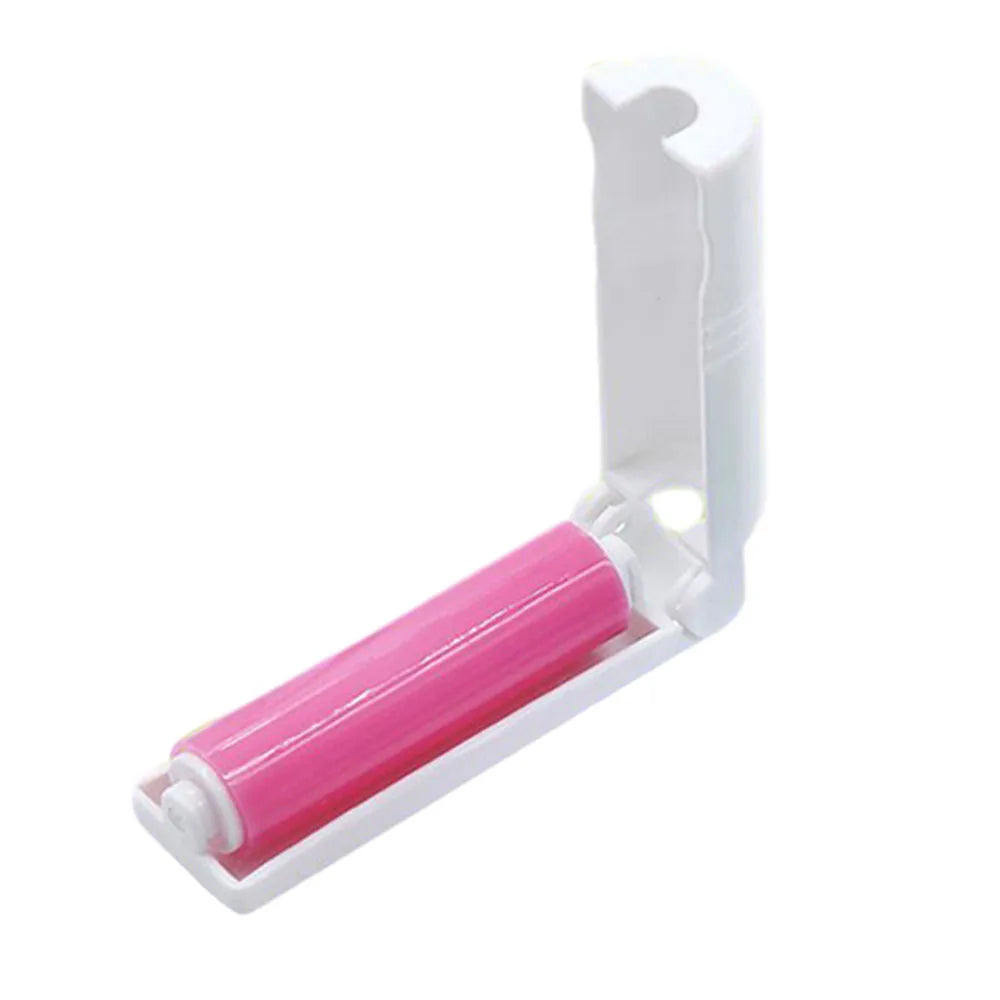 Pink lint roller with white handle on a white background