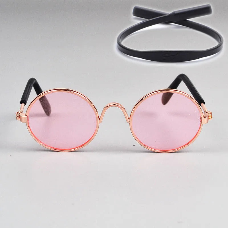 Round pink sunglasses with black cat-eye frames for pets