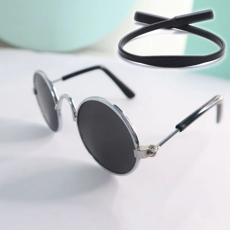 Round sunglasses for pets with black lenses and silver frames