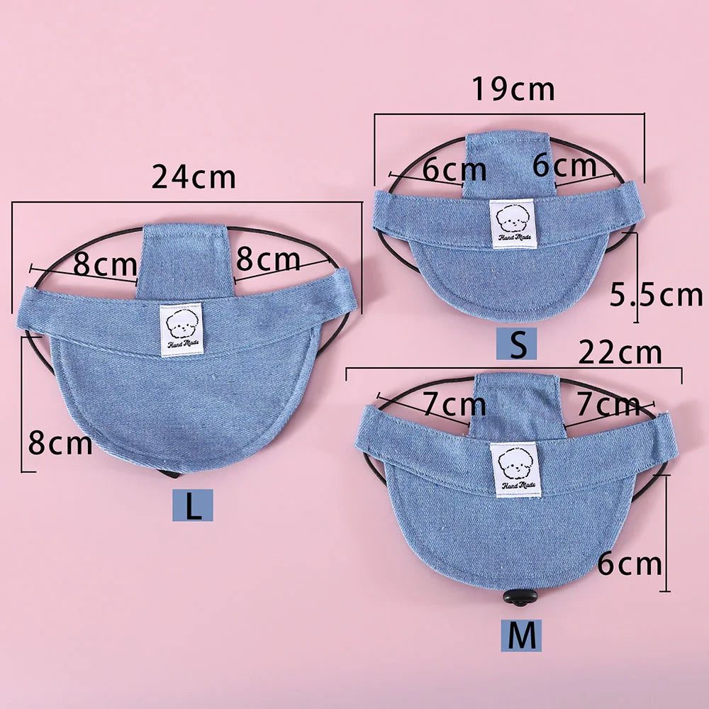 Three denim pet hats with measurements on a pink background