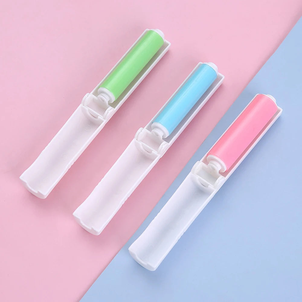 Three lint roller attachments in pastel green, light blue, and pink, arranged diagonally on a split pink and light blue background.