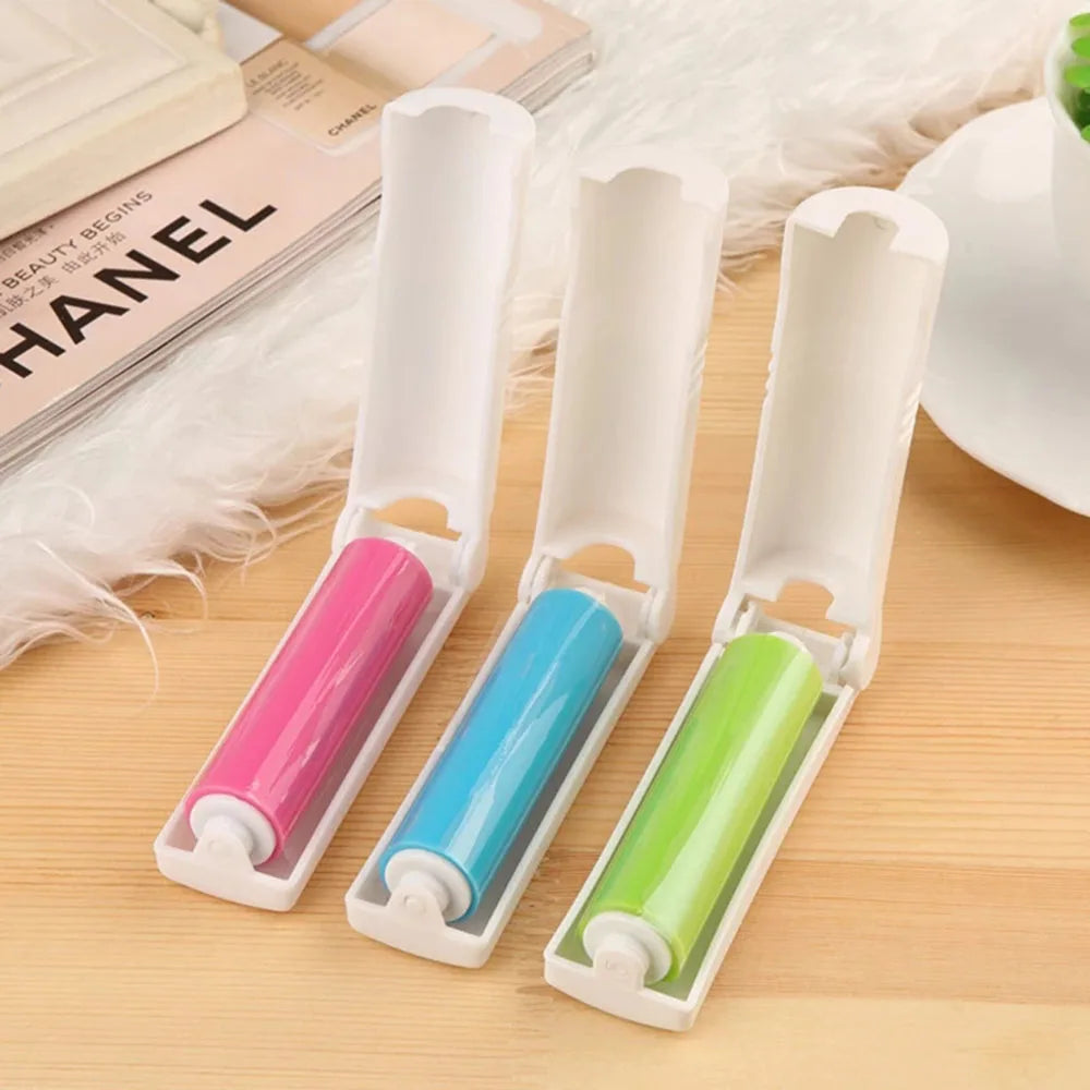 Three lint roller attachments in pink, blue, and green, shown in their white plastic cases 