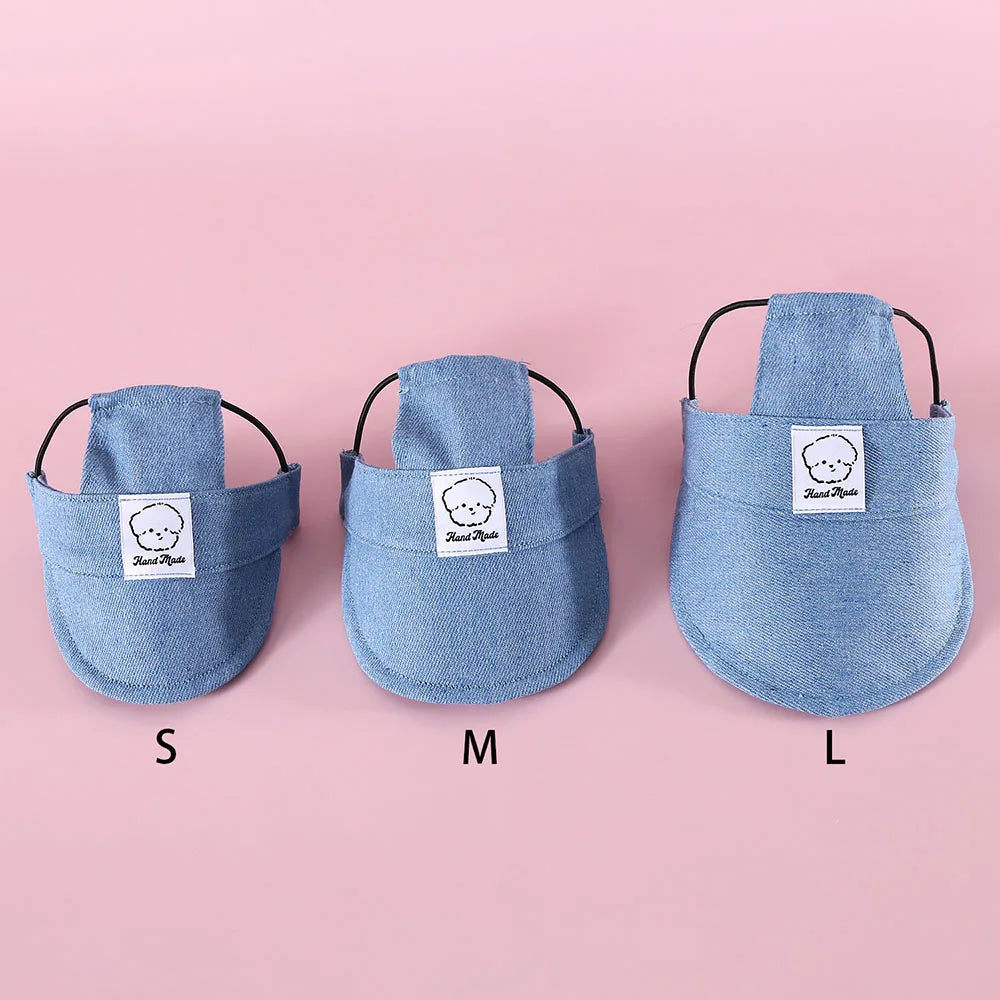 Three sizes of blue pet hat labeled S, M, and L on a pink background.